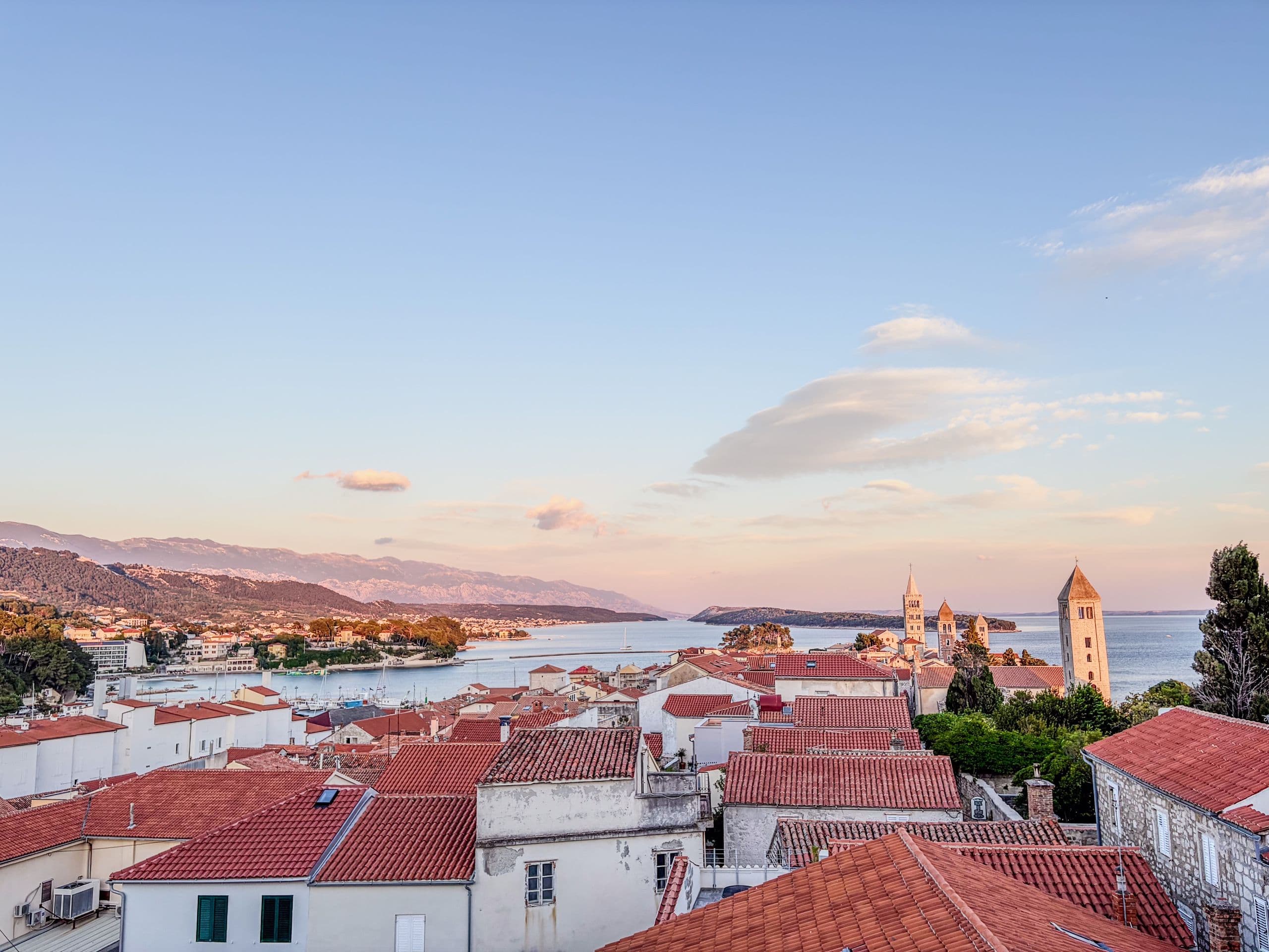 Rab old town rooftops at golden hour.